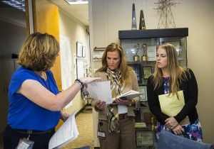 Corporate Marketing and Communications members Paula Lukowski, left, Kim Wear and Althea McMickell discuss social media response tactics during the storm drill. 11/4/15